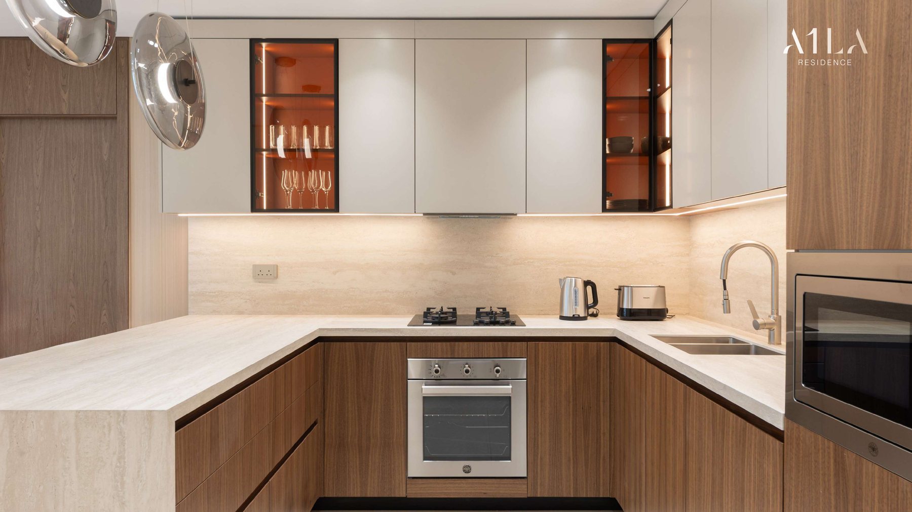 A fitted kitchen at A1LA Residence with integrated appliances