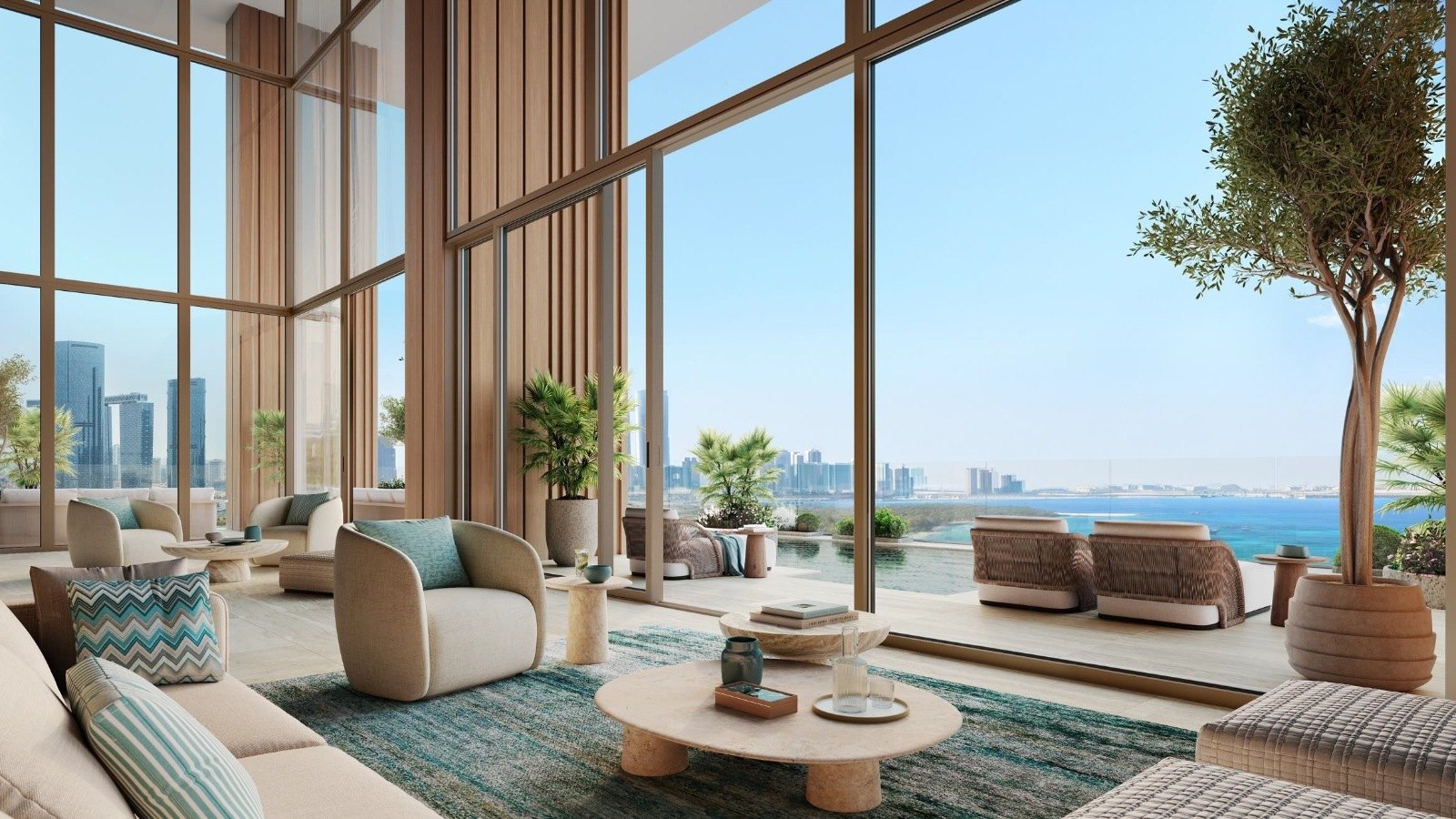 A double-height living room at Residence 77 with full-height glazing onto the sea