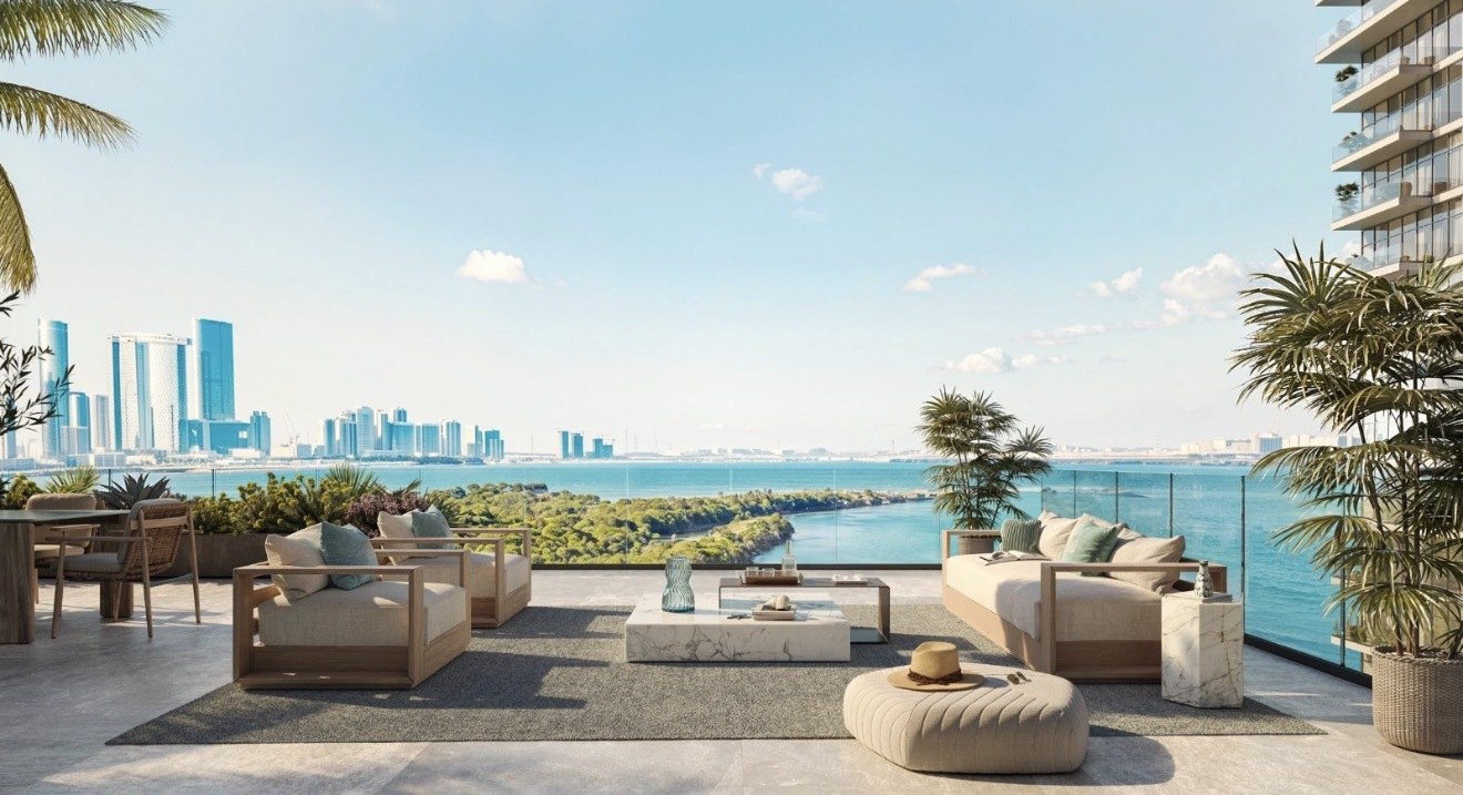 A rooftop terrace at Residence 77 overlooking the water and the city skyline