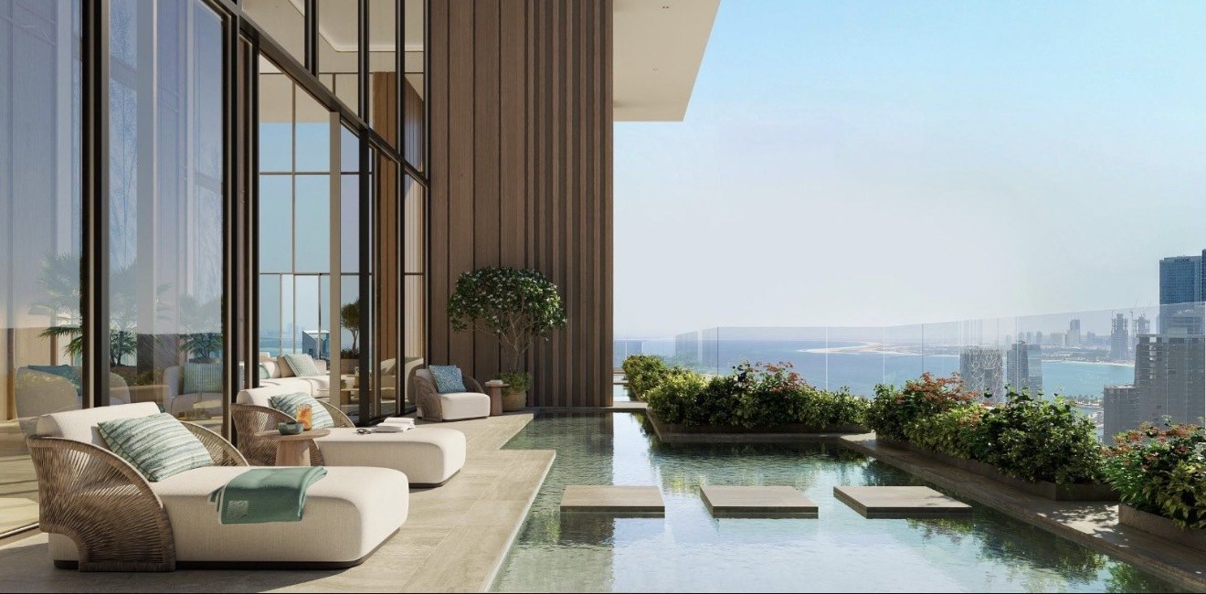 A terrace and pool at Residence 77 looking out over the water