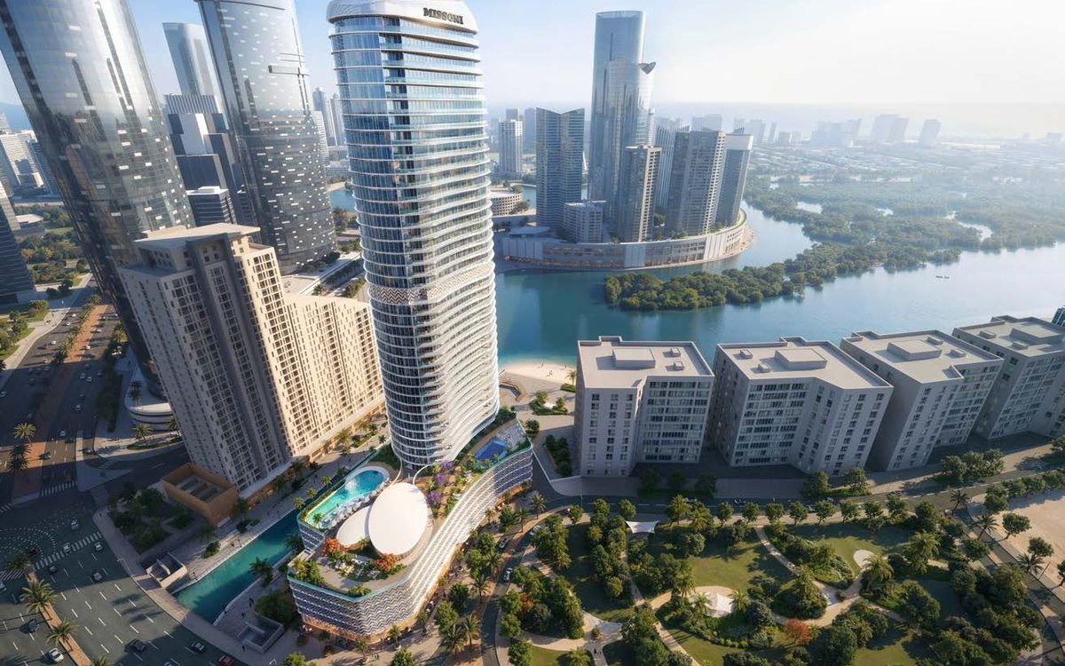 Aerial view of Waterfront by Missoni, a curved tower between the canal and the mangroves on Al Reem Island