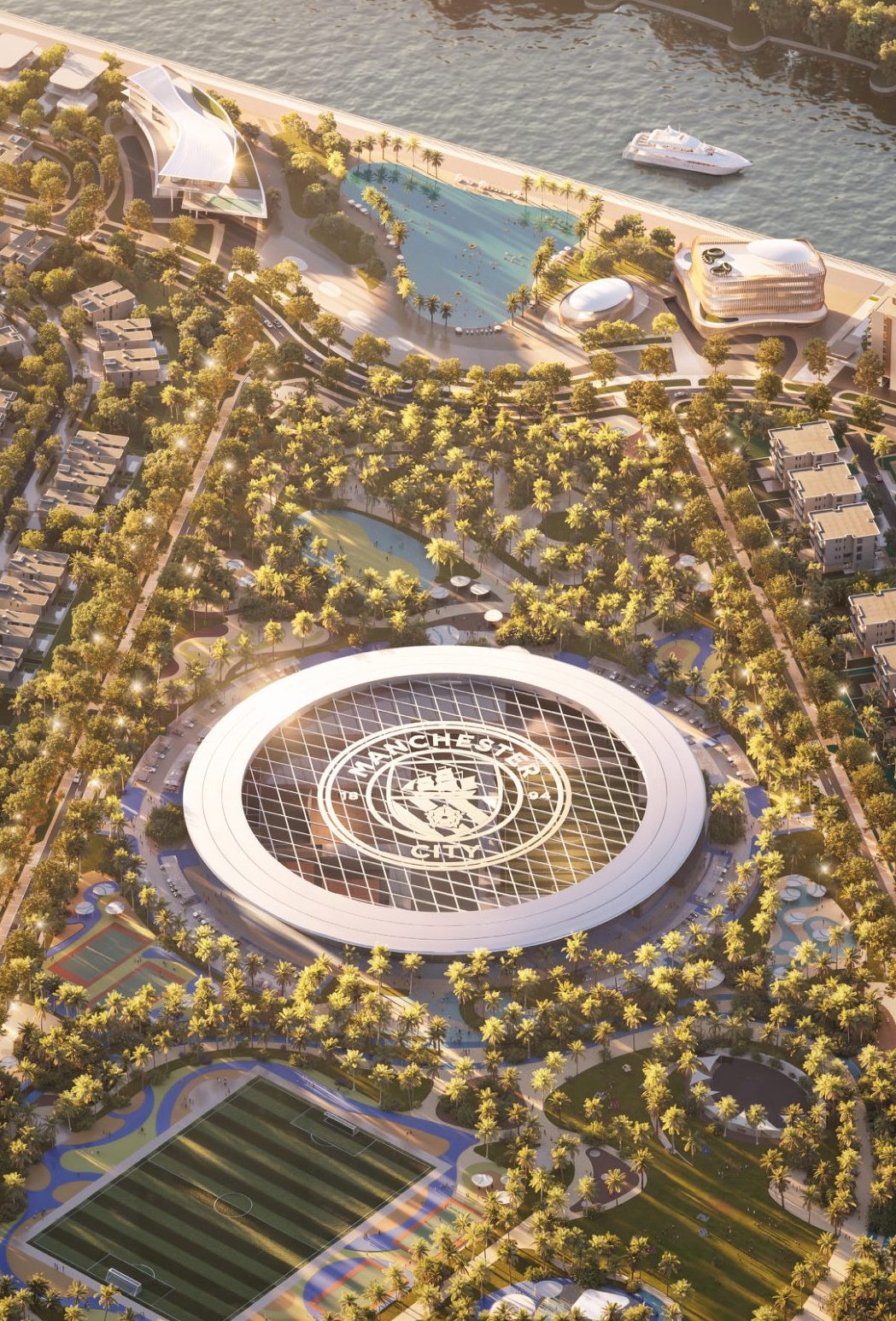 Aerial render of the community: the arena with the Manchester City crest, a football pitch, palm-lined streets and the lagoon and canal beyond