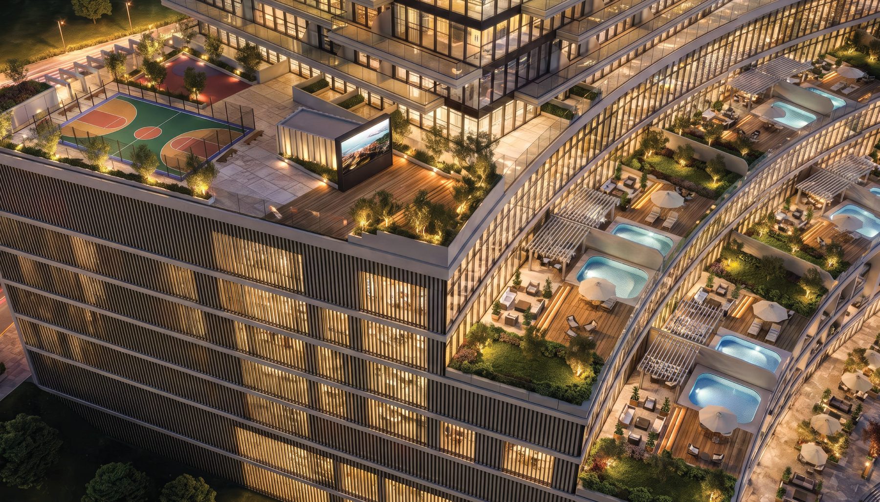 The amenity deck at Radiant Terrace at night: sports court, outdoor cinema and terrace pools