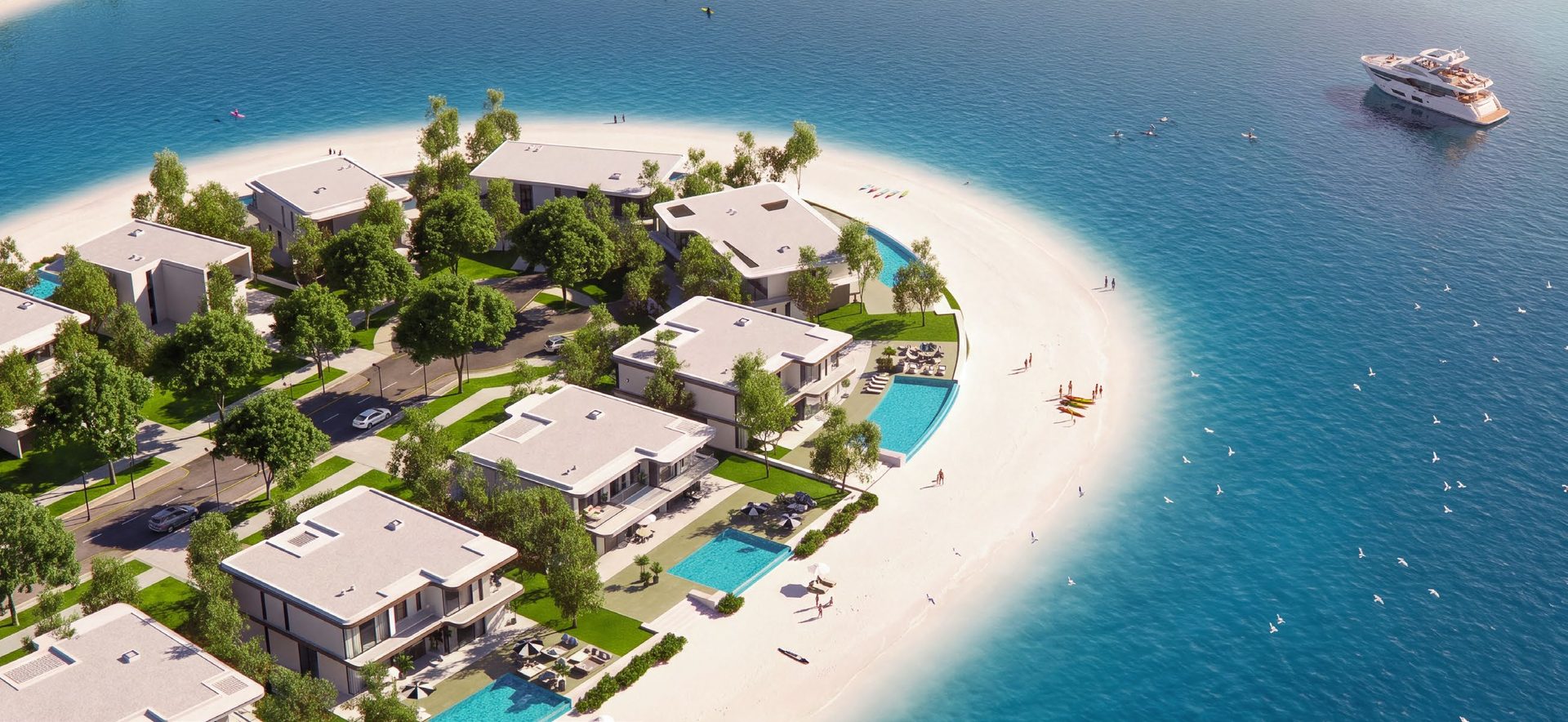 Villas on a sandy point at Ramhan Island with a yacht offshore