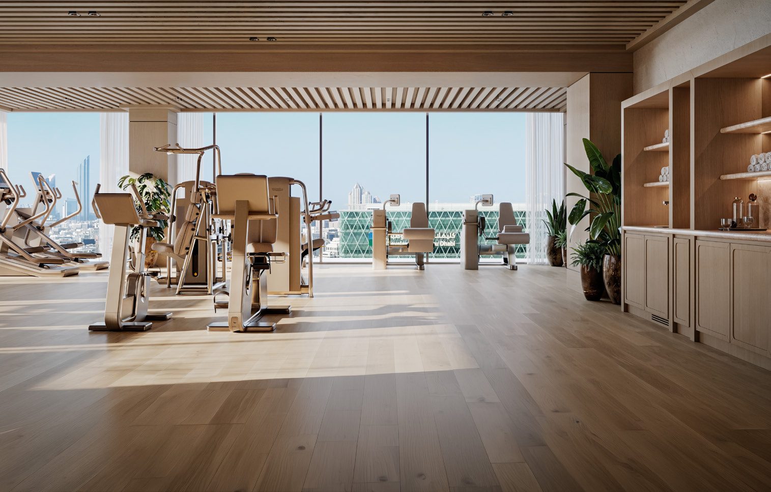 The fitness studio with equipment facing panoramic city views