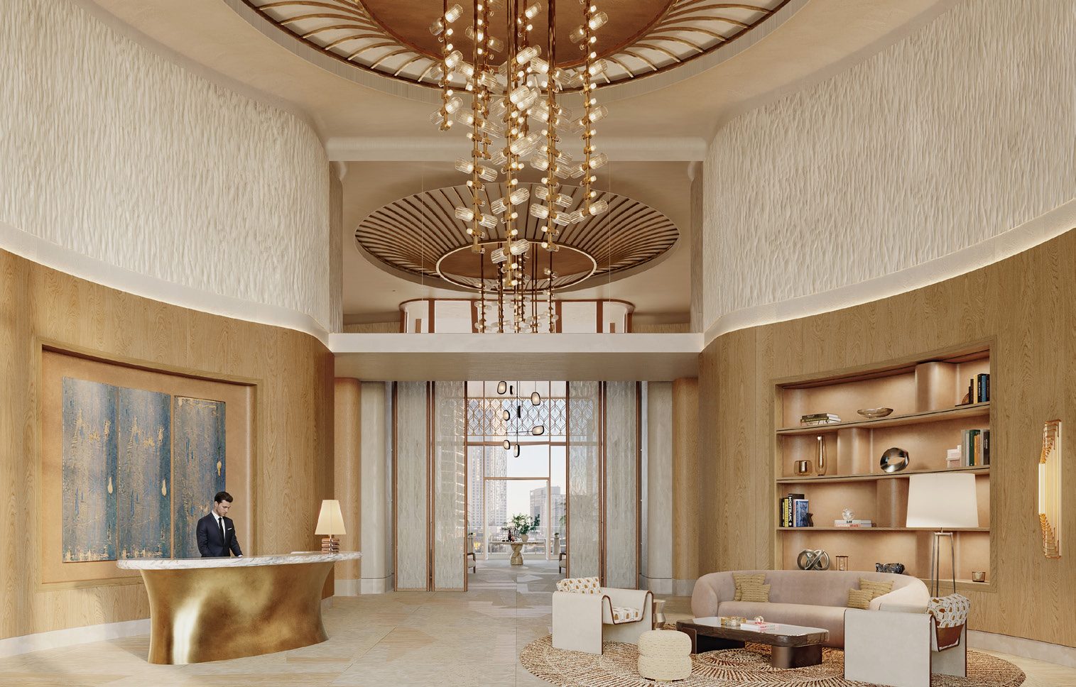 The double-height arrival lobby with a sculptural chandelier and a concierge desk