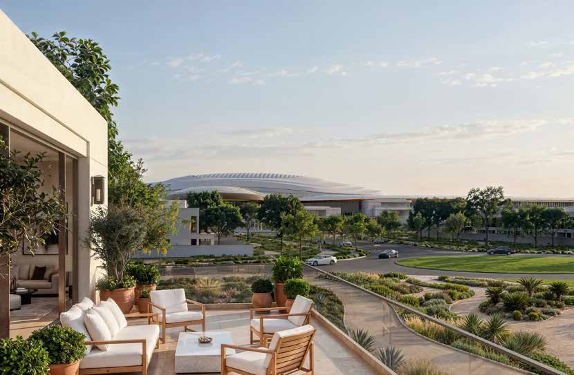 A villa terrace at Wadeem Gardens looking across landscaped gardens towards the arena on Hudayriyat Island